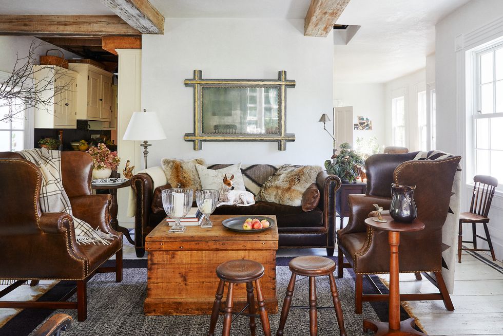 a farmhouse living room with leather furniture