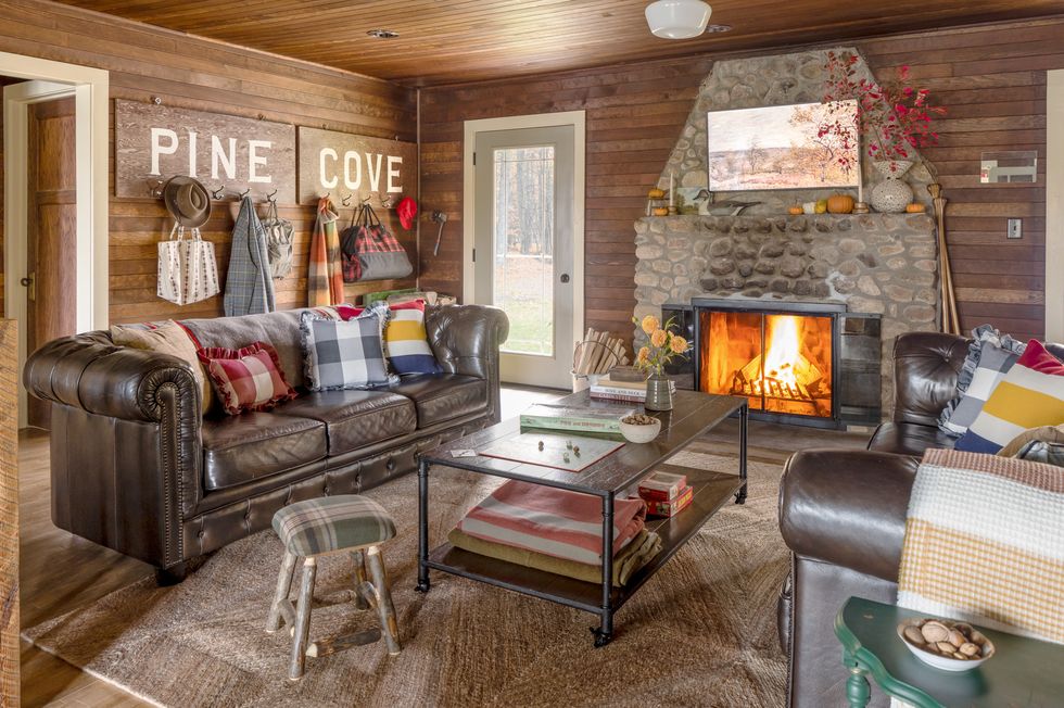 the marsh family cabin in wisconsin with a roaring fire and a leather sofa