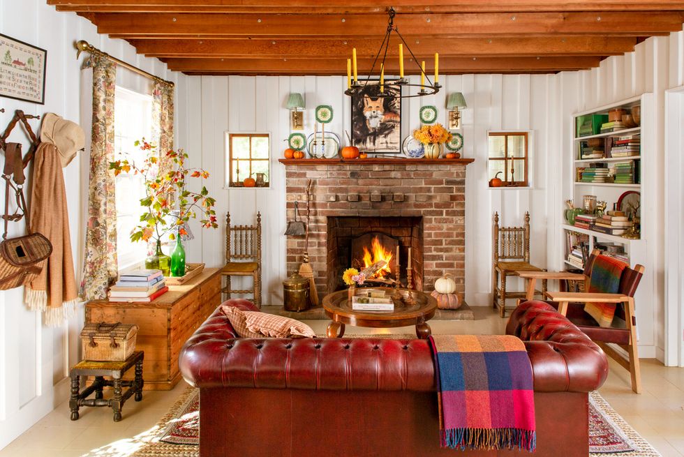 a cottage in the blue ridge mountains that has a living room with a fireplace and a leather sofa