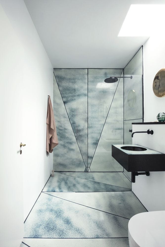 Bathroom with Lava stone panel wall and floor in art deco shapes Bathroom with Lava stone panel wall and floor in art deco shapes