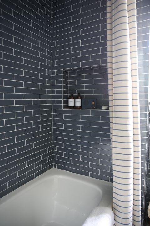 bathroom, blue subway tile, bathtub, white and blue shower curtain