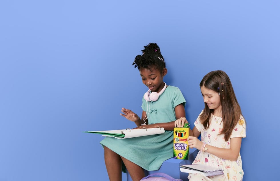 two children engaged in a creative activity with art supplies