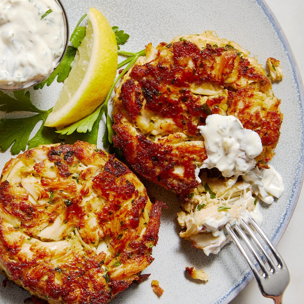 flaky crab cakes stacked and served with tartar sauce