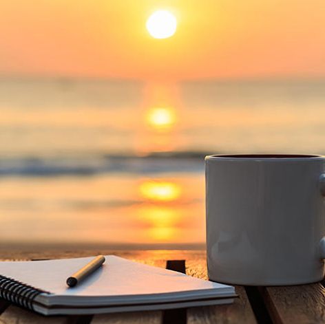 A coffee cup amidst a sunrise. 