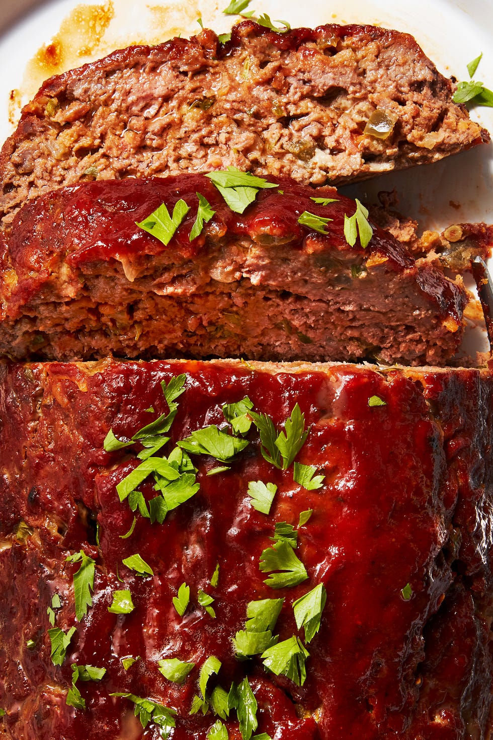 Cracker Barrel Meatloaf Meatloaf topped with sauce and fresh herbs