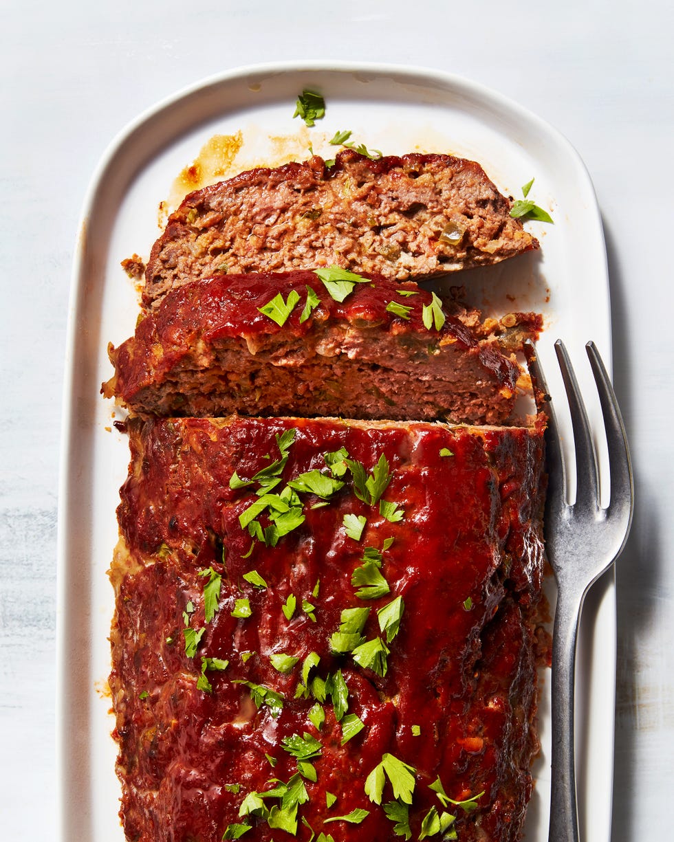 meatloaf topped with sauce and fresh herbs