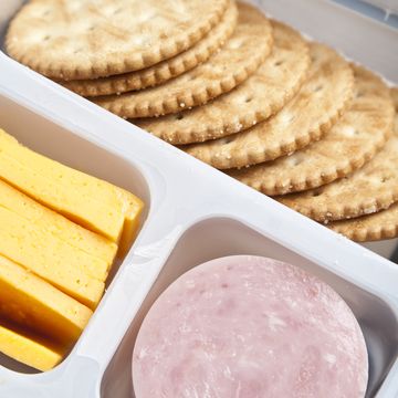 crackers, sliced cheese and ham in a plastic tray