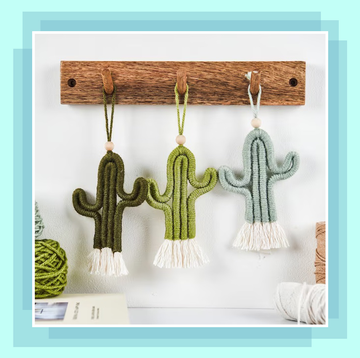 macrame cacti hanging on a wooden board