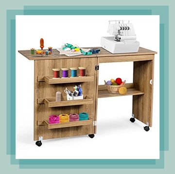 craft table with sewing machine and craft supplies