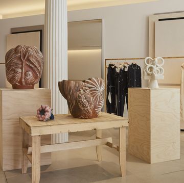 a room with a table and a display of clothing
