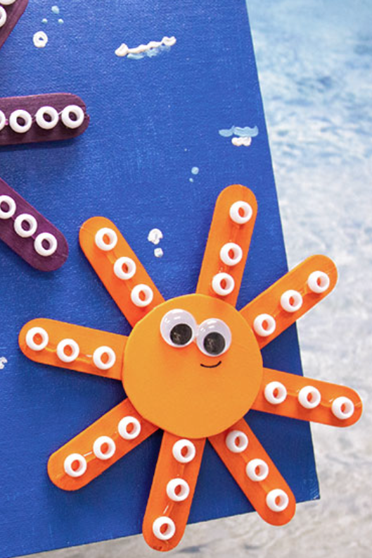 crafts for kids, craft stick octopus with googly eyes and smiley faces