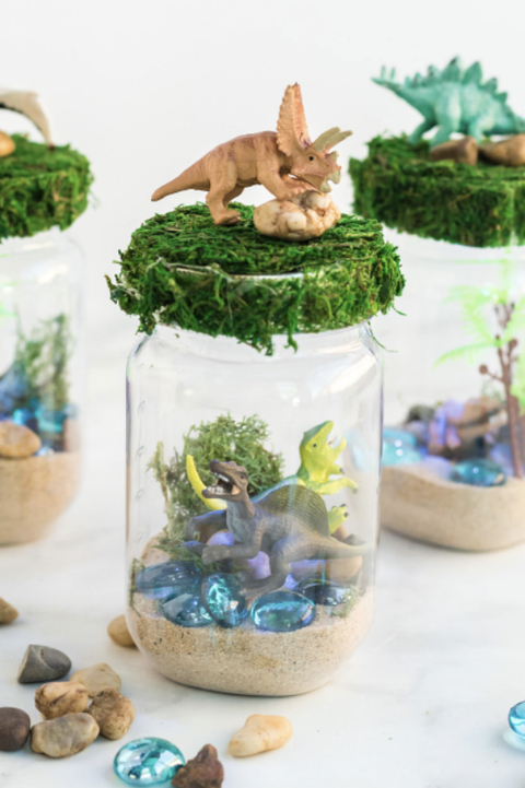 crafts for kids, mason jar with toy dinosaurs inside and greenery at the top