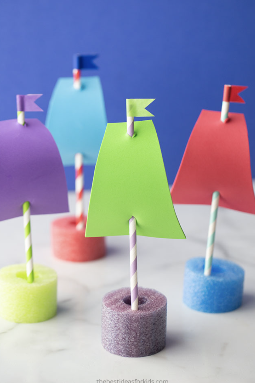 crafts for kids, tiny boats made with pool noodles and paper straws, with flags on top