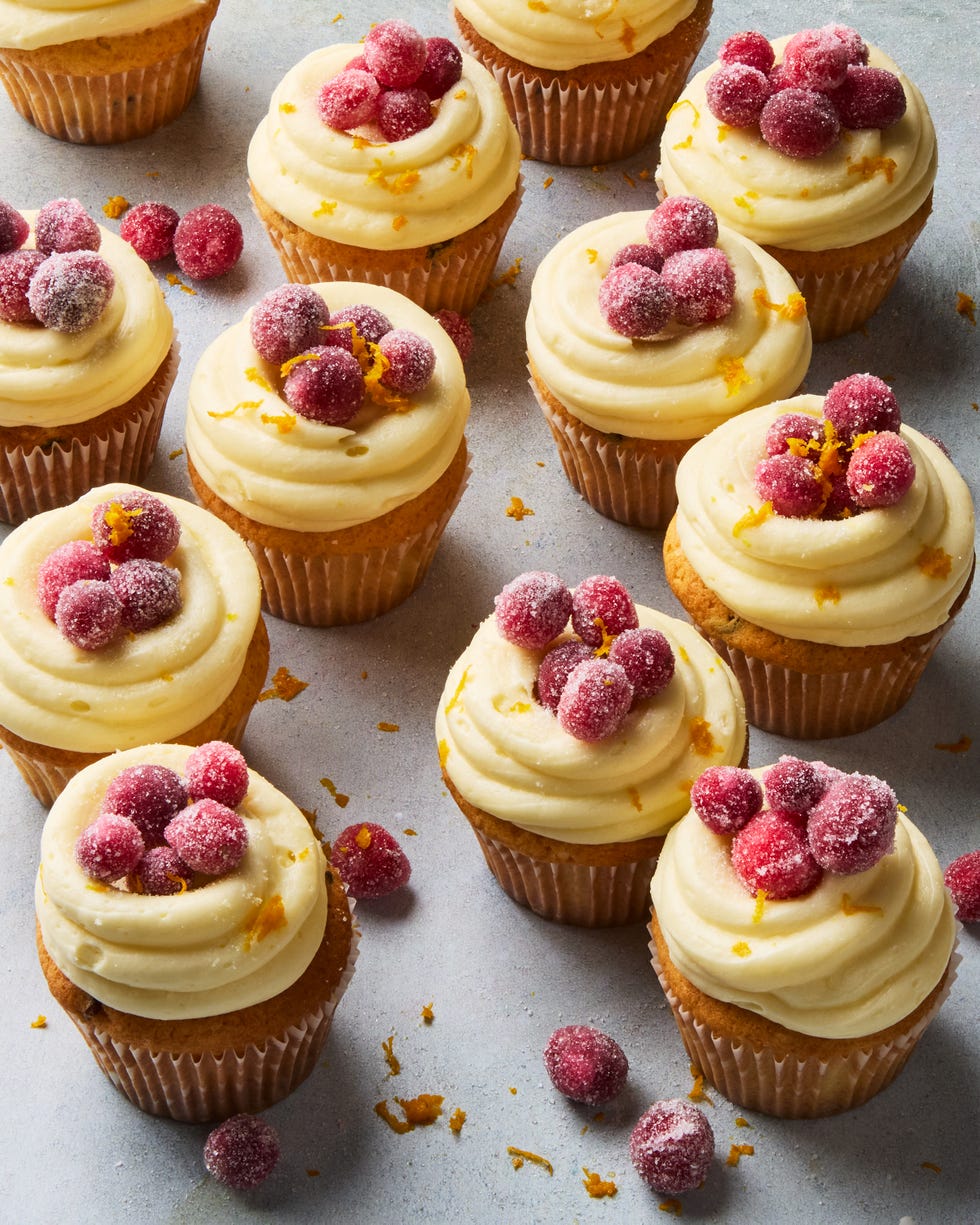 cupcakes topped with icing and sugared cranberries