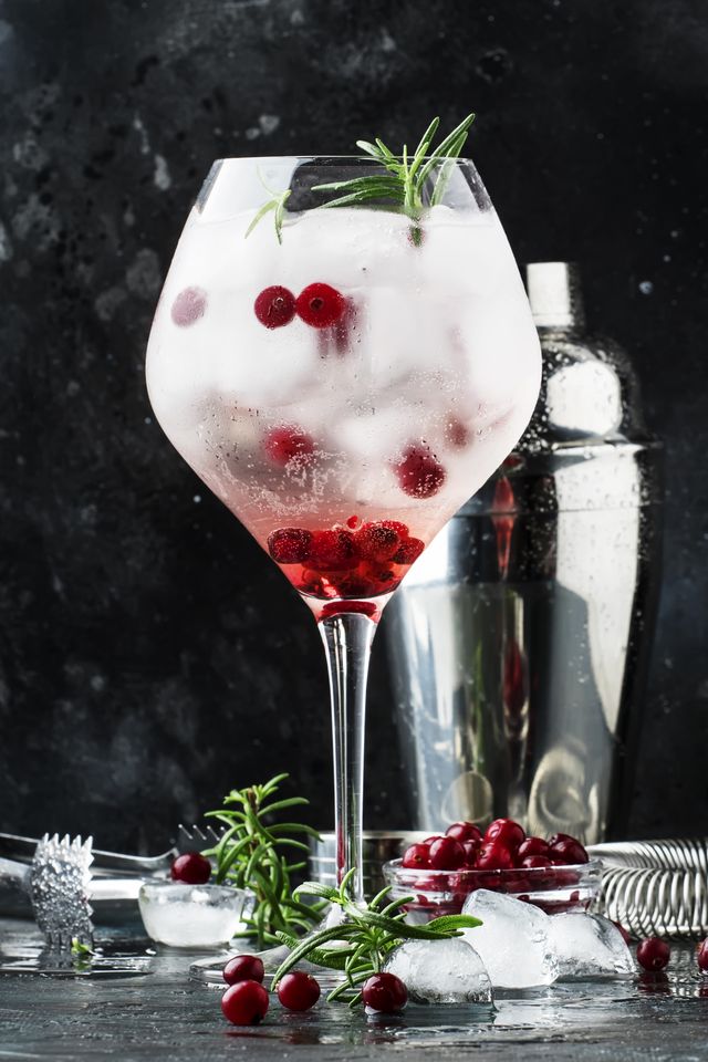 Cranberry Cocktail With Ice, Fresh Rosemary And Red Berries In B