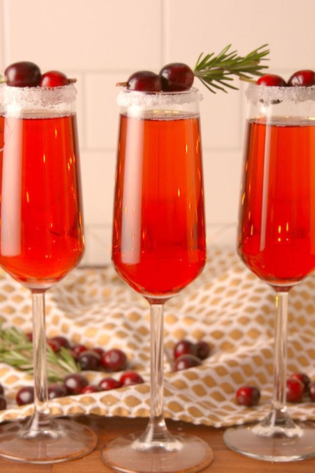 red cranberry mimosa with cranberries on top
