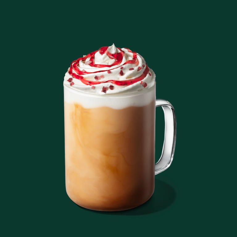 layered beverage topped with whipped cream and syrup