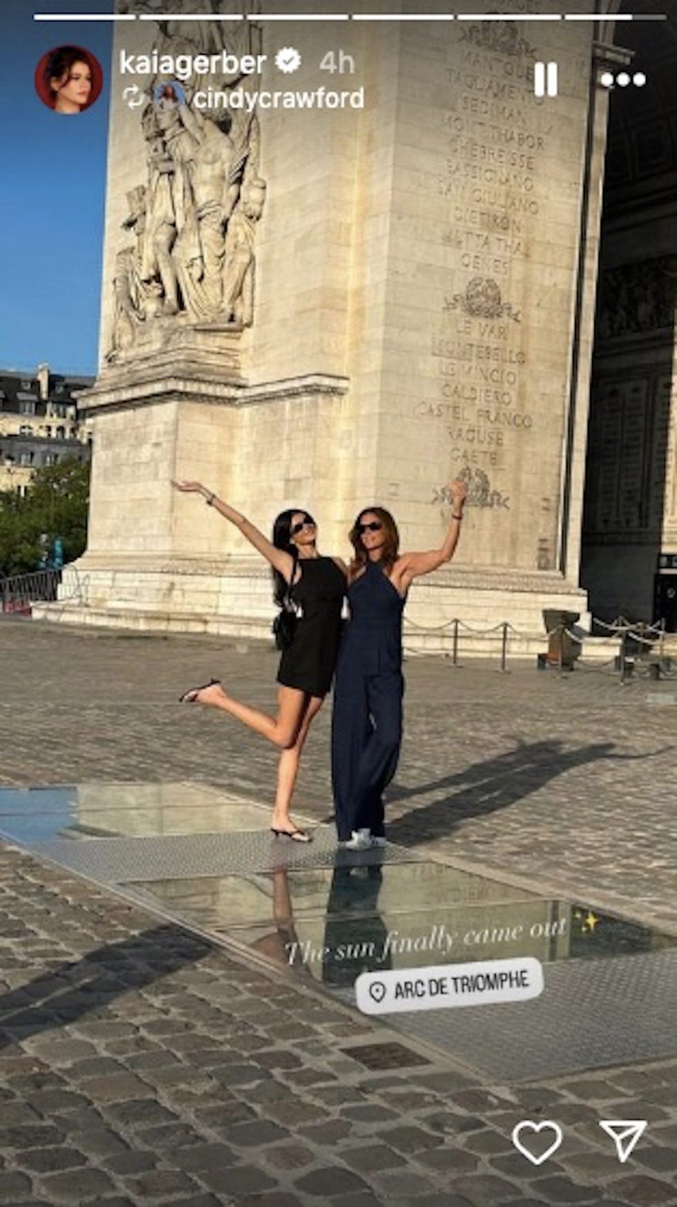 two women posing in front of a building