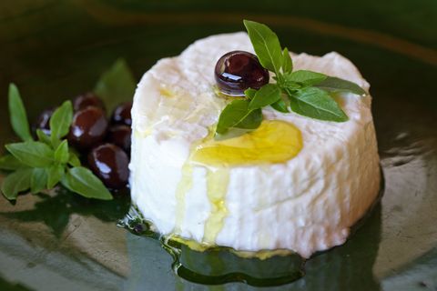 cream cheese from goat milk with olive oil, olives and fresh basil, provence