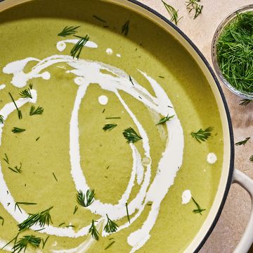 cream of asparagus soup drizzled with cream and topped with dill
