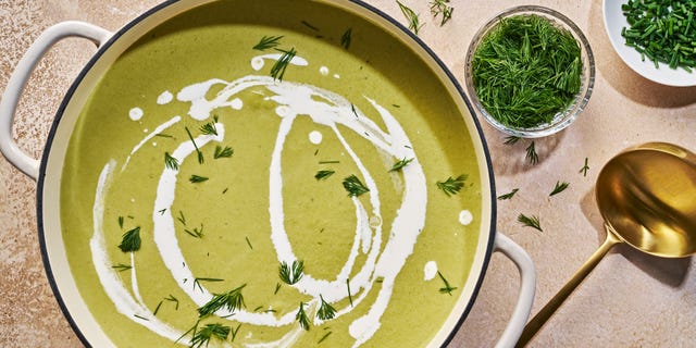 cream of asparagus soup drizzled with cream and topped with dill