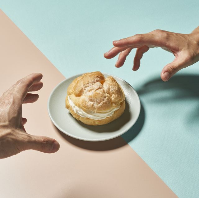 cream puff and hands on a colorful background