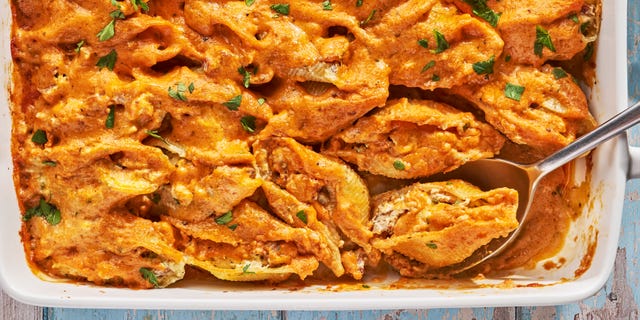 creamy cajun stuffed shells in a white baking dish