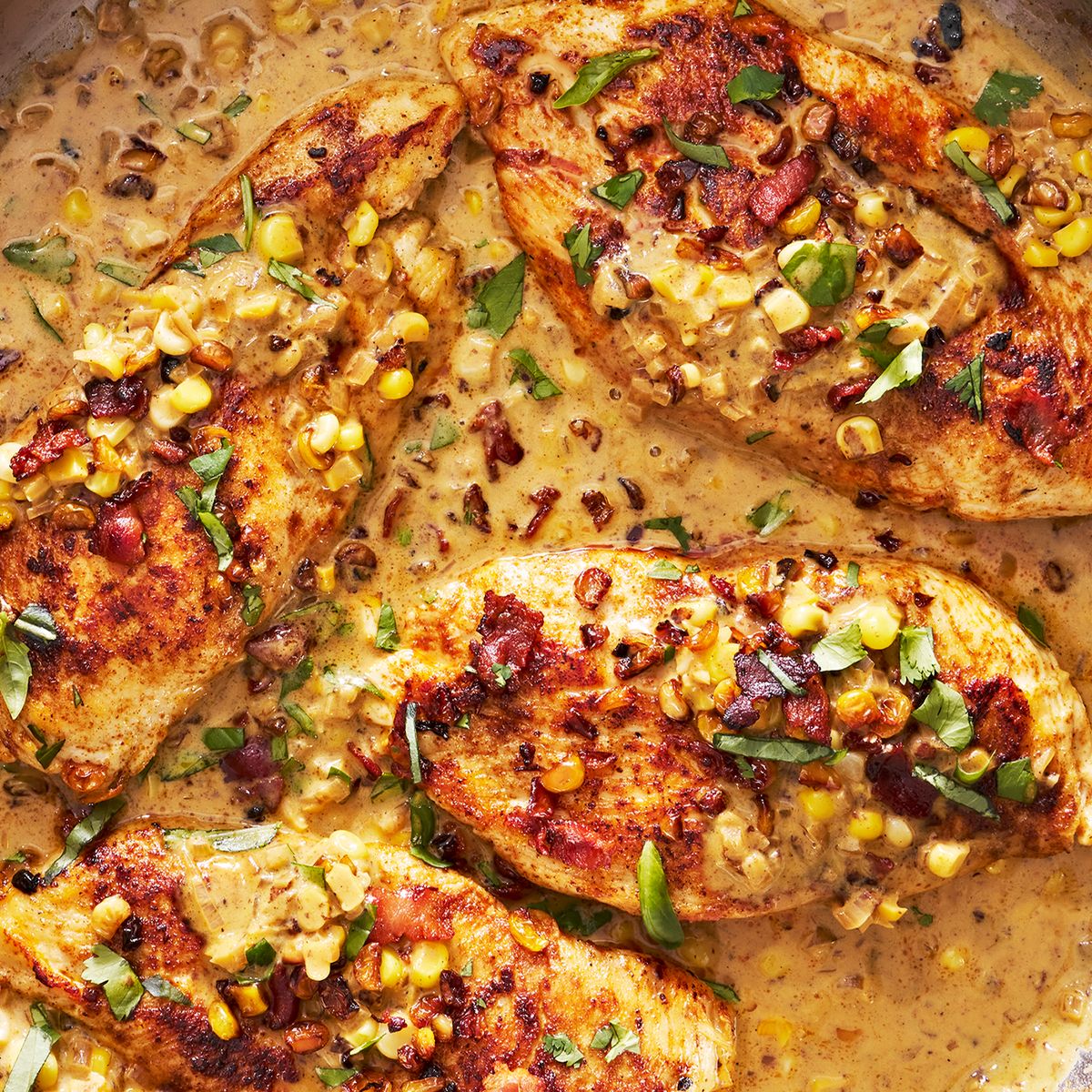 chicken breasts in a creamy sauce with corn and bacon