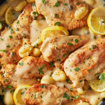 creamy chicken piccata with gnocchi in a pan with lemon