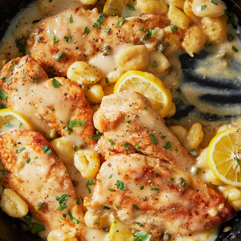 creamy chicken piccata with gnocchi in a pan with lemon