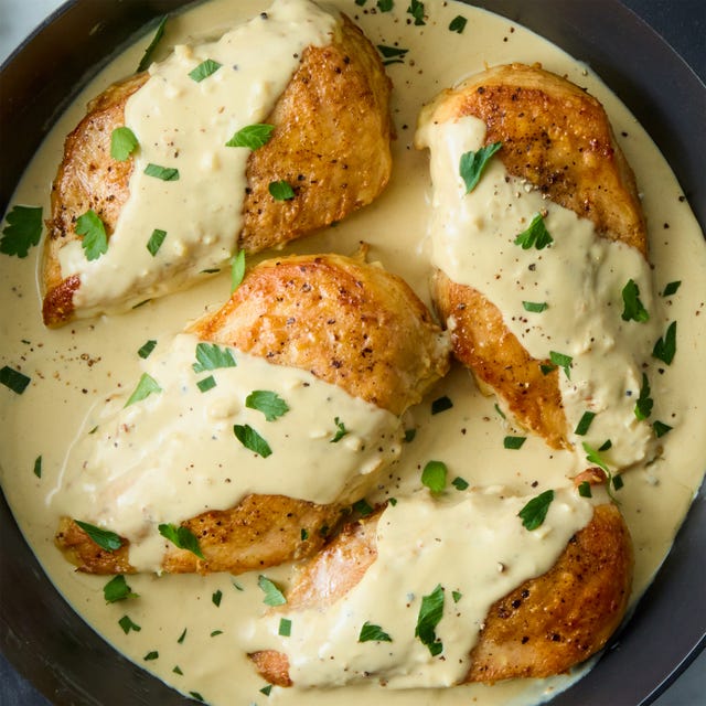 Creamy Dijon Chicken chicken breasts topped with a creamy dijon mustard sauce and fresh herbs