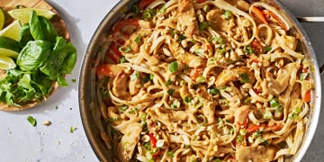 chicken with noodles and carrots in a creamy peanut lime sauce topped with peanuts