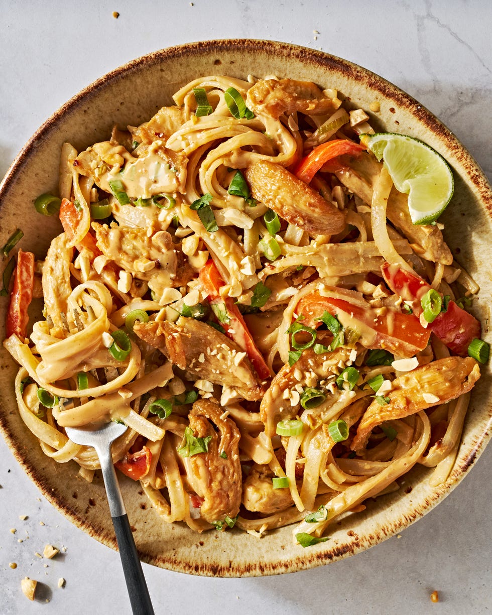 chicken with noodles and carrots in a creamy peanut lime sauce topped with peanuts