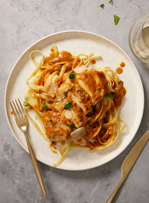 creamy pumpkin and parmesan chicken with linguine, topped with green onions