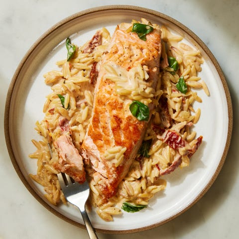 creamy sundried tomato salmon orzo topped with fresh basil