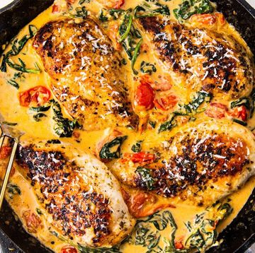 chicken breasts in a creamy tuscan sauce in a cast iron skillet