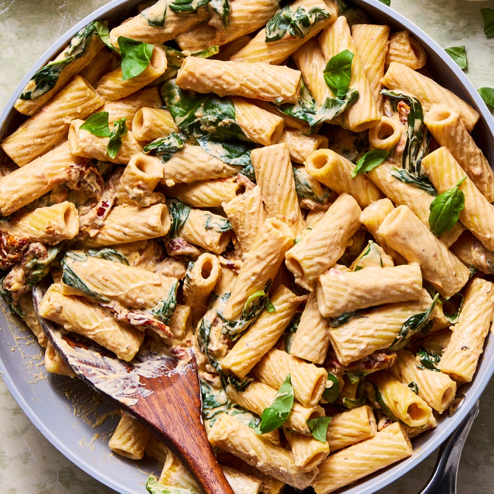 rigatoni tossed in a creamy vegan tuscan sauce with spinach and sundried tomatoes