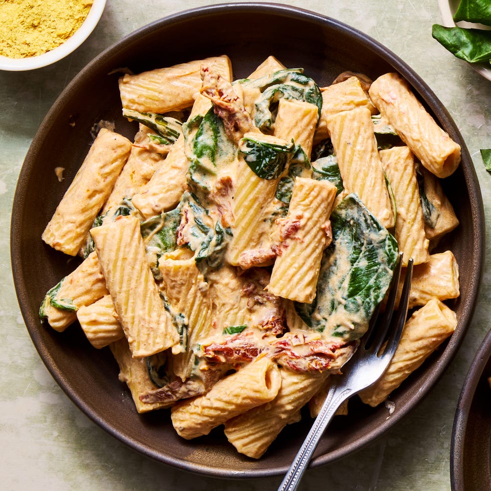 rigatoni tossed in a creamy vegan tuscan sauce with spinach and sundried tomatoes