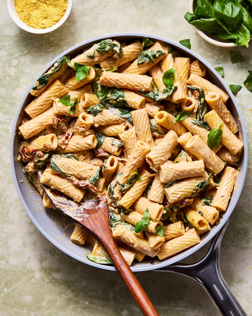 rigatoni tossed in a creamy vegan tuscan sauce with spinach and sundried tomatoes