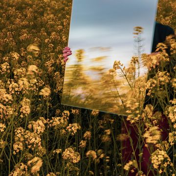creative picture of rectangle mirror reflecting landscape in nature with motion
