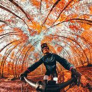 creative selfie picture riding mountain bike in autumn forest in spain