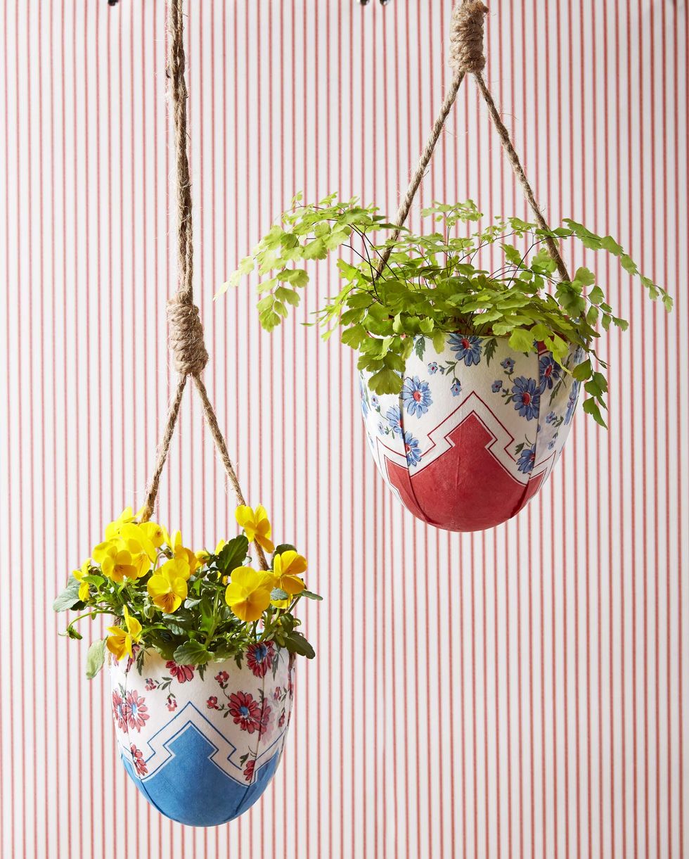 hanging pots that have been covered in vintage hankies and are filled with yellow blooms