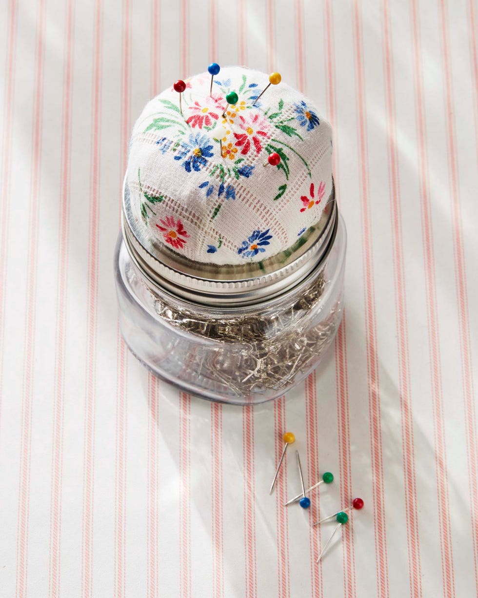 a mason jar with a pin cushion top made from a vintage hankie