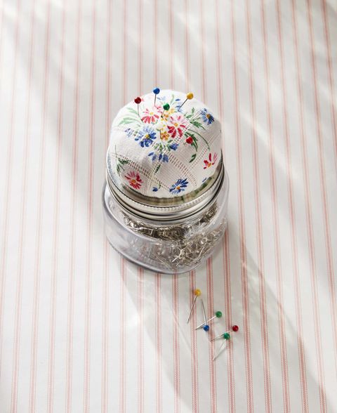 a mason jar with a pin cushion top made from a vintage hankie
