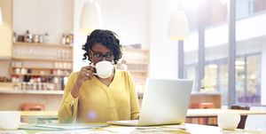 Creative woman working at desk with coffee