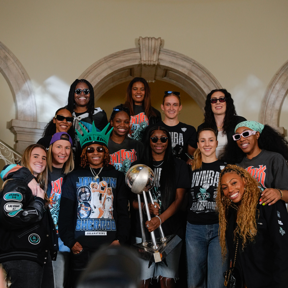 Group celebrating with a championship trophy and themed attire