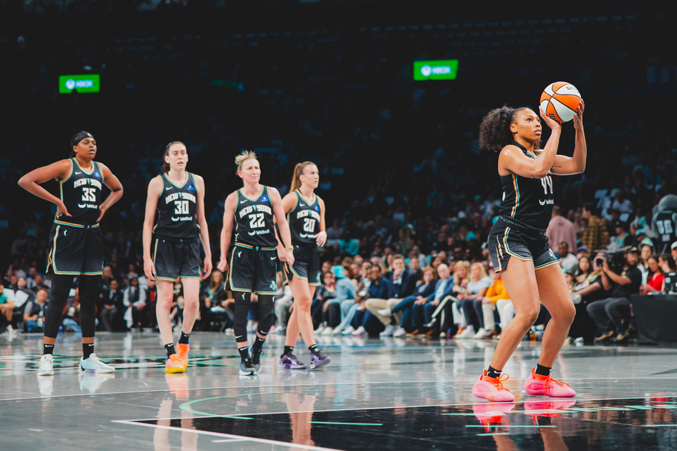 Players in a basketball game preparing for a play