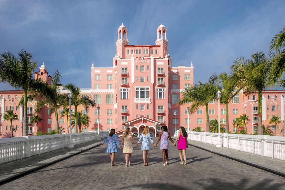 four women walking outside of the don cesar in florida