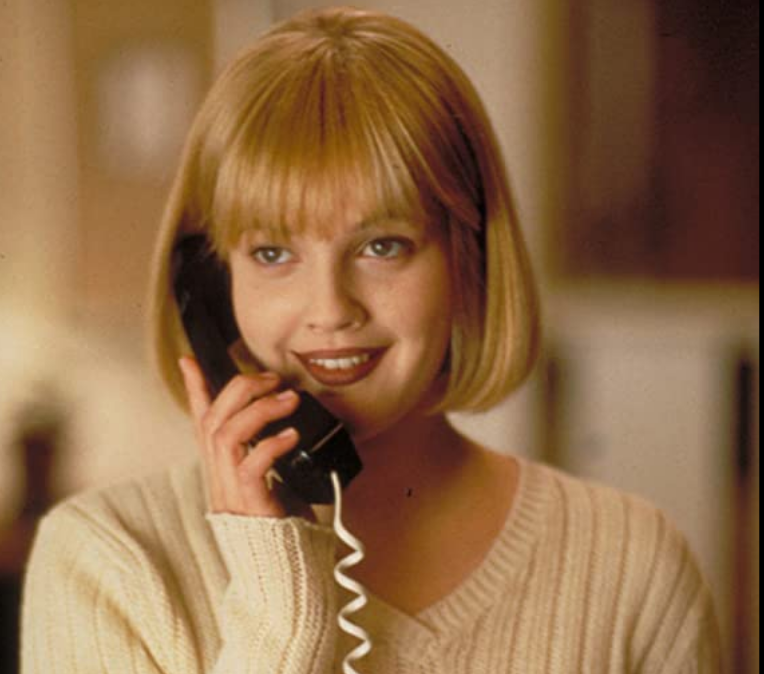a person talking on a black telephone
