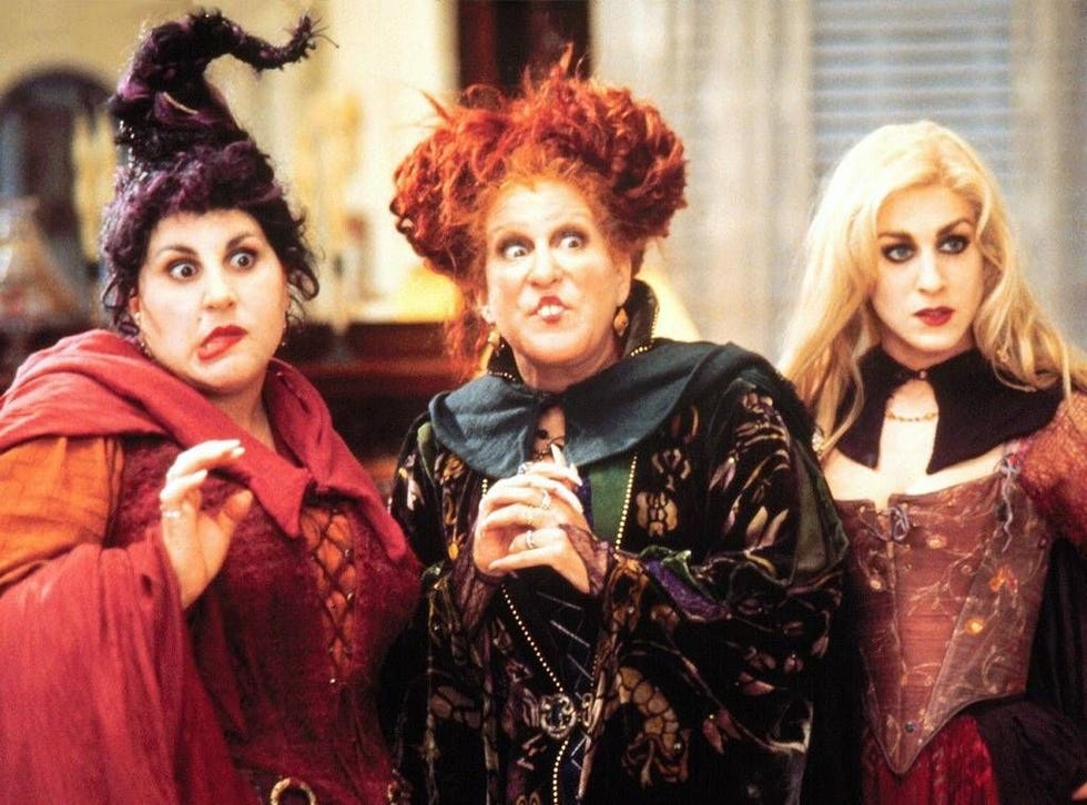 Three witches posing together in elaborate costumes Three witches posing together in elaborate costumes
